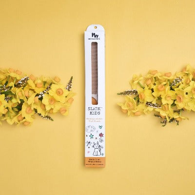 kids-hair-comb-in-box-on-yellow-background