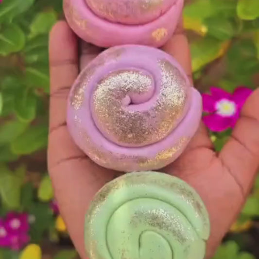 A DIY playdough kit box with various natural colored playdoughs and accessories displayed around it, including containers of powder and spices.