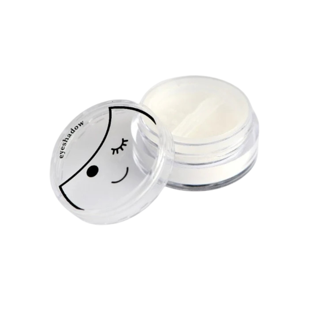 Eyeshadow compact with a smiley face design on the lid against a white background