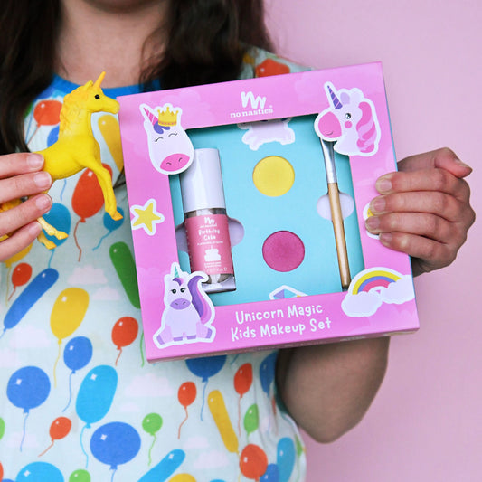 Unicorn-themed kids makeup set with a pink box on a yellow background