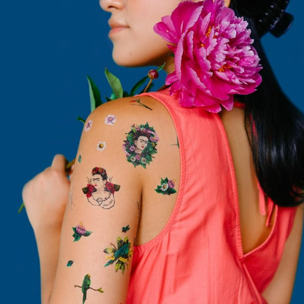 frida-kahlo-tattoos-on-woman-flower-blue-background