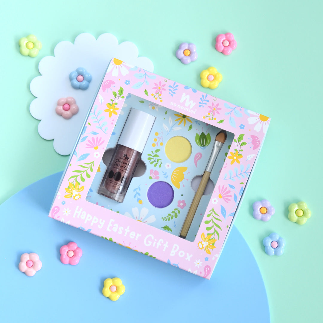 Makeup set in a decorative box with floral design on a colorful background