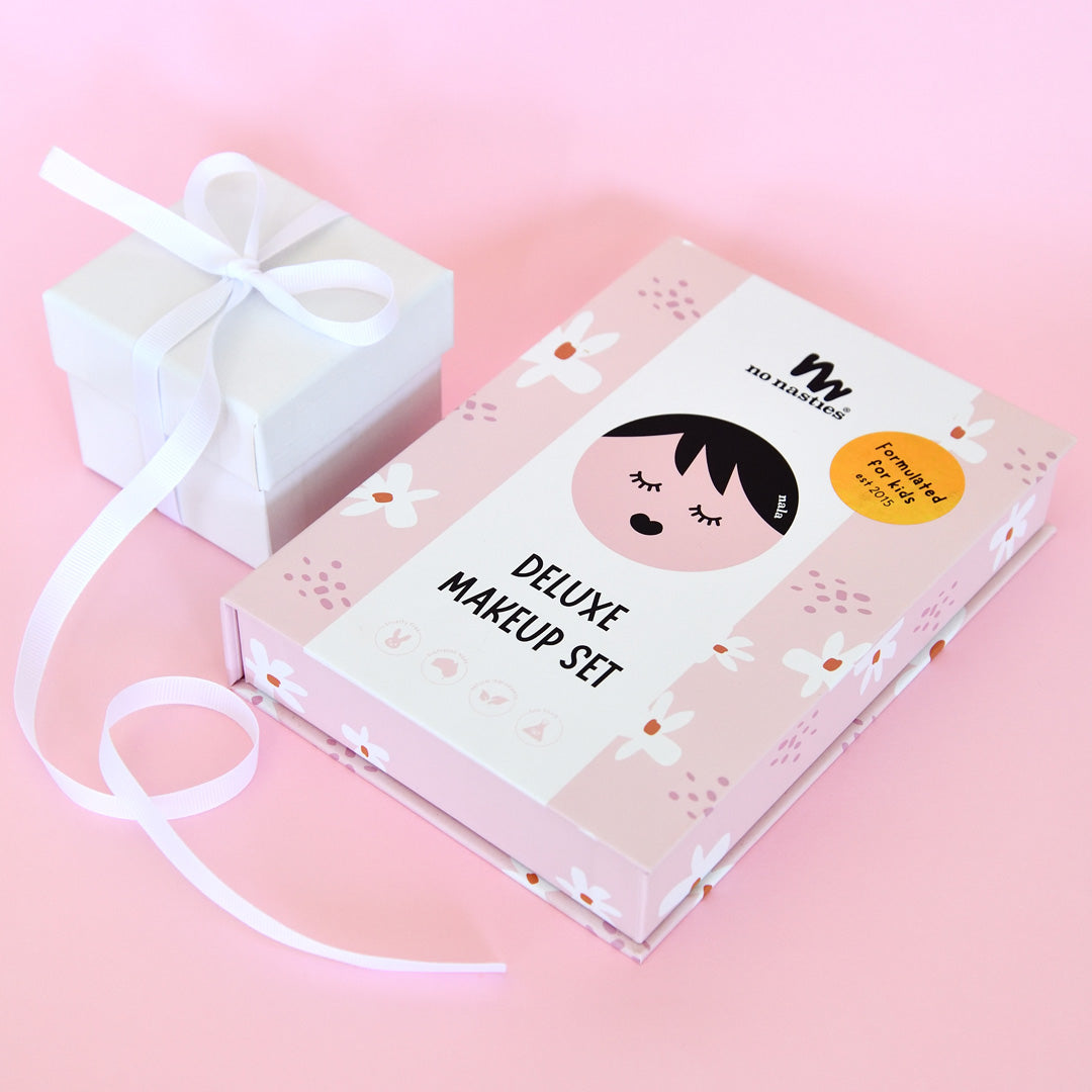 Deluxe makeup set packaging with cartoon character on a pink background