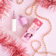 Cosmetic products with decorative tinsel and beads on a pink background