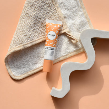 Tube of 'ME ME' skincare product on a textured surface with a decorative letter 'S'.