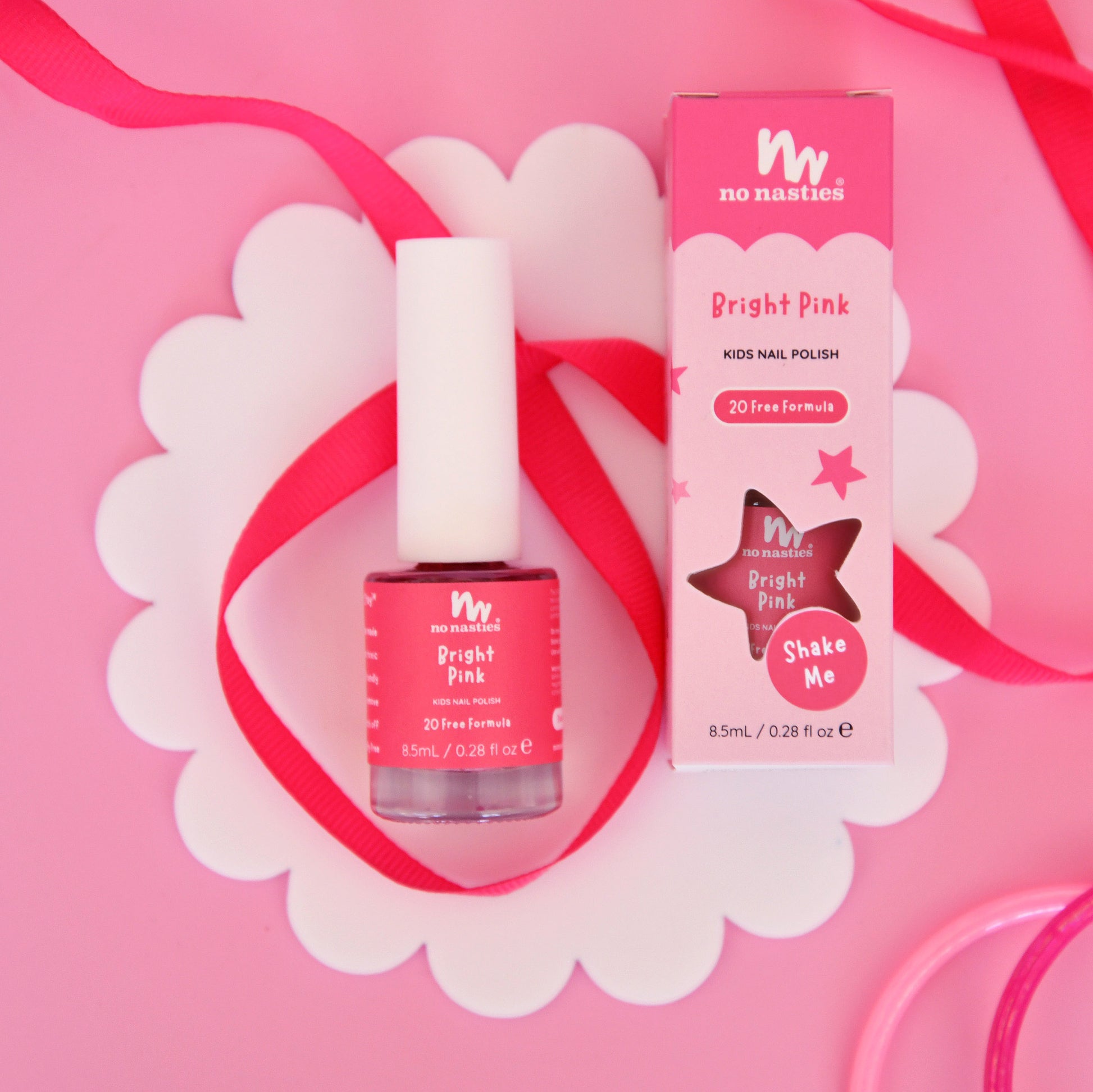 Bright Pink nail polish bottle and packaging on a pink background with decorative elements.