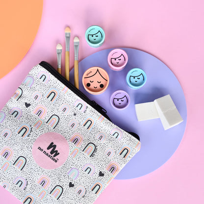 Makeup tools including brushes, a palette, and a pouch with 'no nasties' branding on a colorful background.
