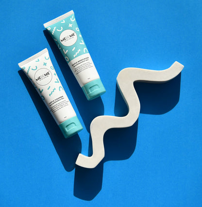 Two ME&ME skincare products on a blue background with a white zigzag object.