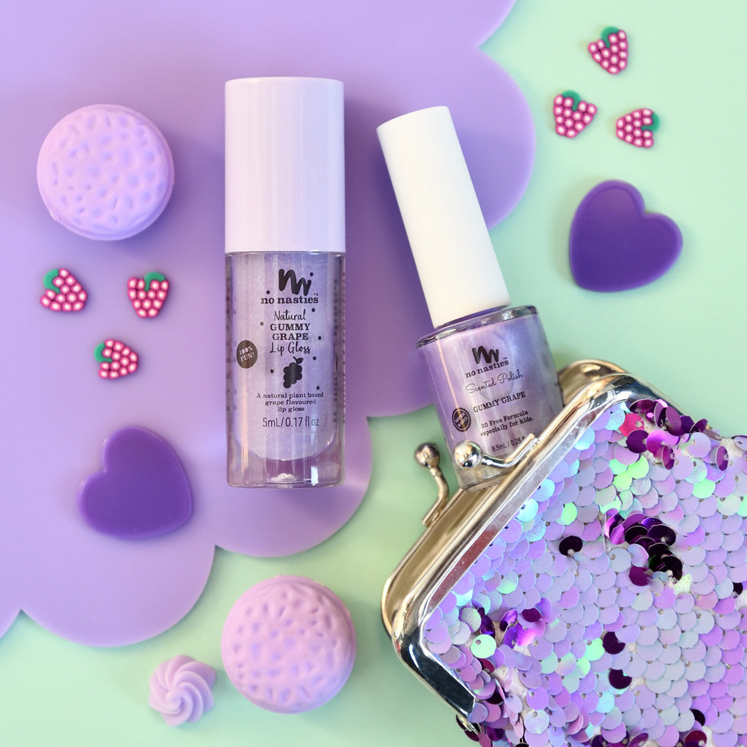 purple-lip-gloss-and-nail-polish-on-purple-and-green-background