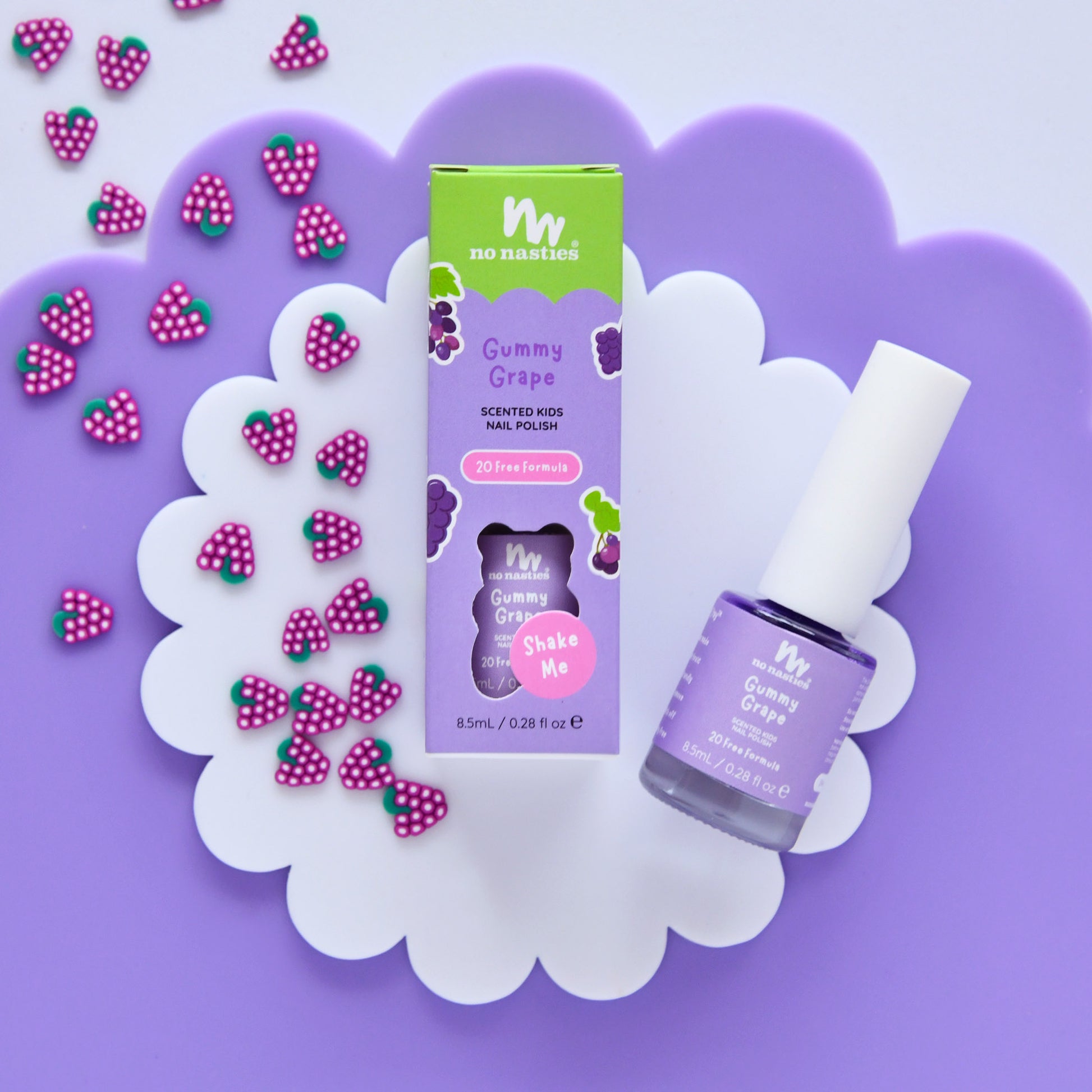 Gummy Grape scented kids' nail polish with packaging on a purple background