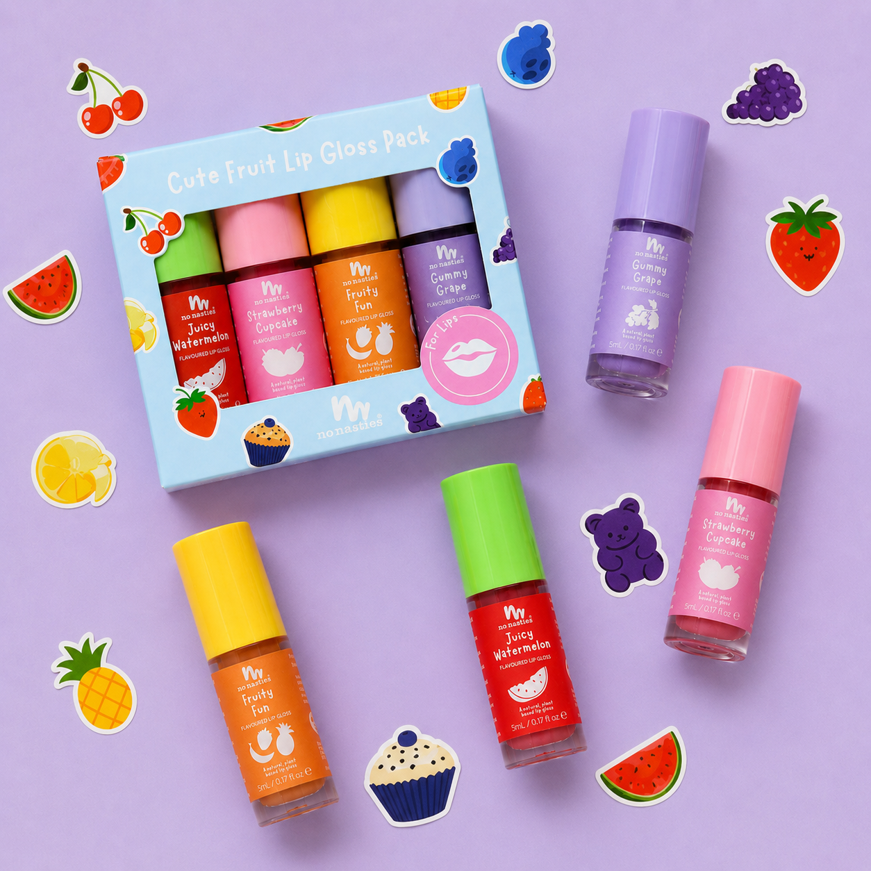 A fruit-themed lip gloss set displayed on a lavender background with decorative fruit stickers. The set includes a light blue box labeled 'Cute Fruit Lip Gloss Pack' and four individual tubes of lip gloss in pink, purple, orange, and red, each with a matching colored cap.