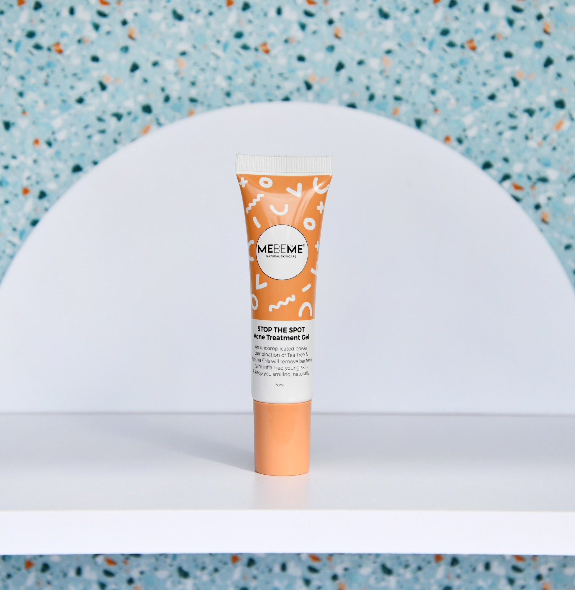 Tube of MeMe Skin treatment gel on a white surface with a blue textured background