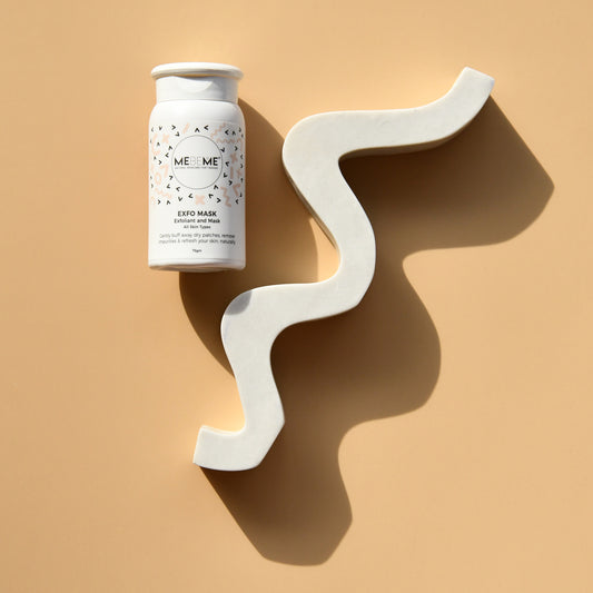 White skincare product container with decorative white wall art on a beige background