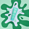Green hair gel tube on a green and white abstract background