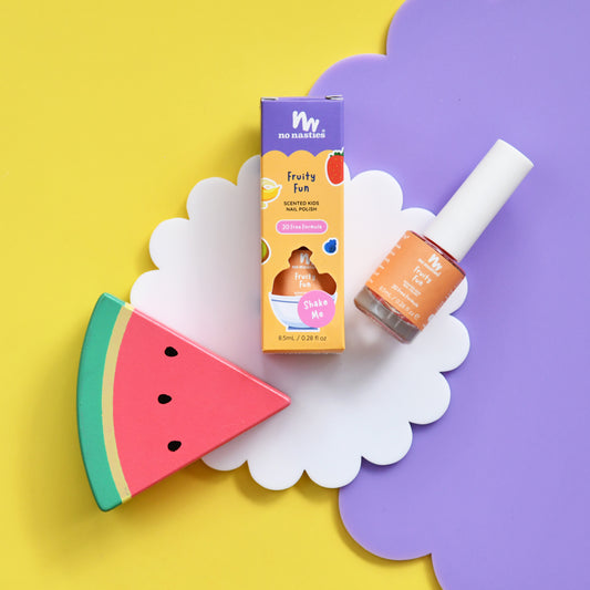Children's nail polish and packaging on a colorful background with a watermelon slice.