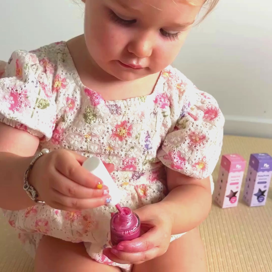 Child applying No Nasties Bright Pink scratch-off kids nail polish