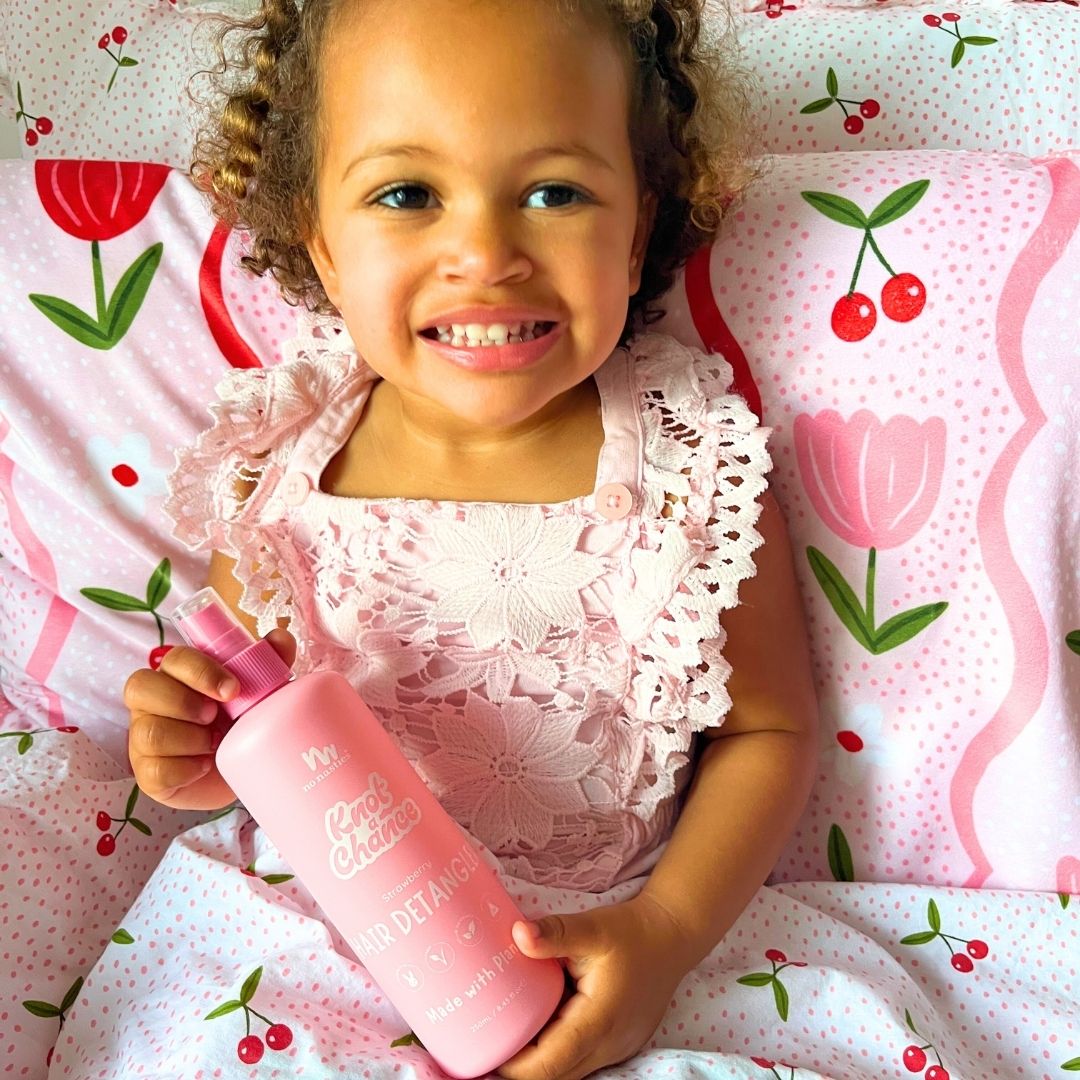 Strawberry kids hair detangler spray bottle on display