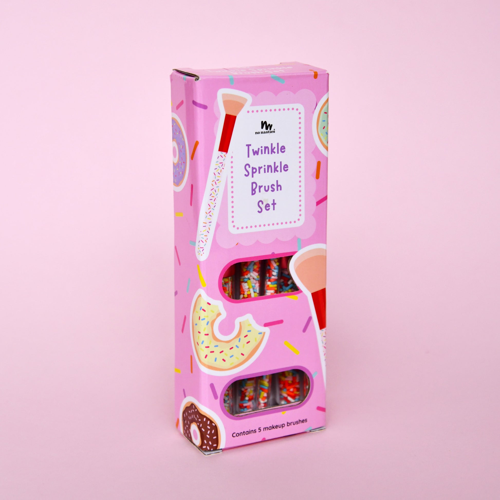 Pink packaging of a 'Twinkle Sprinkle Brush Set' on a pink background