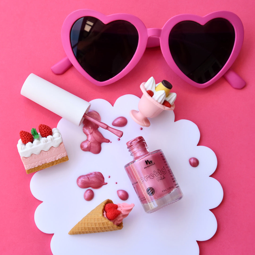 bright-pink-nail-polish-with-heart-shaped-sunglasses