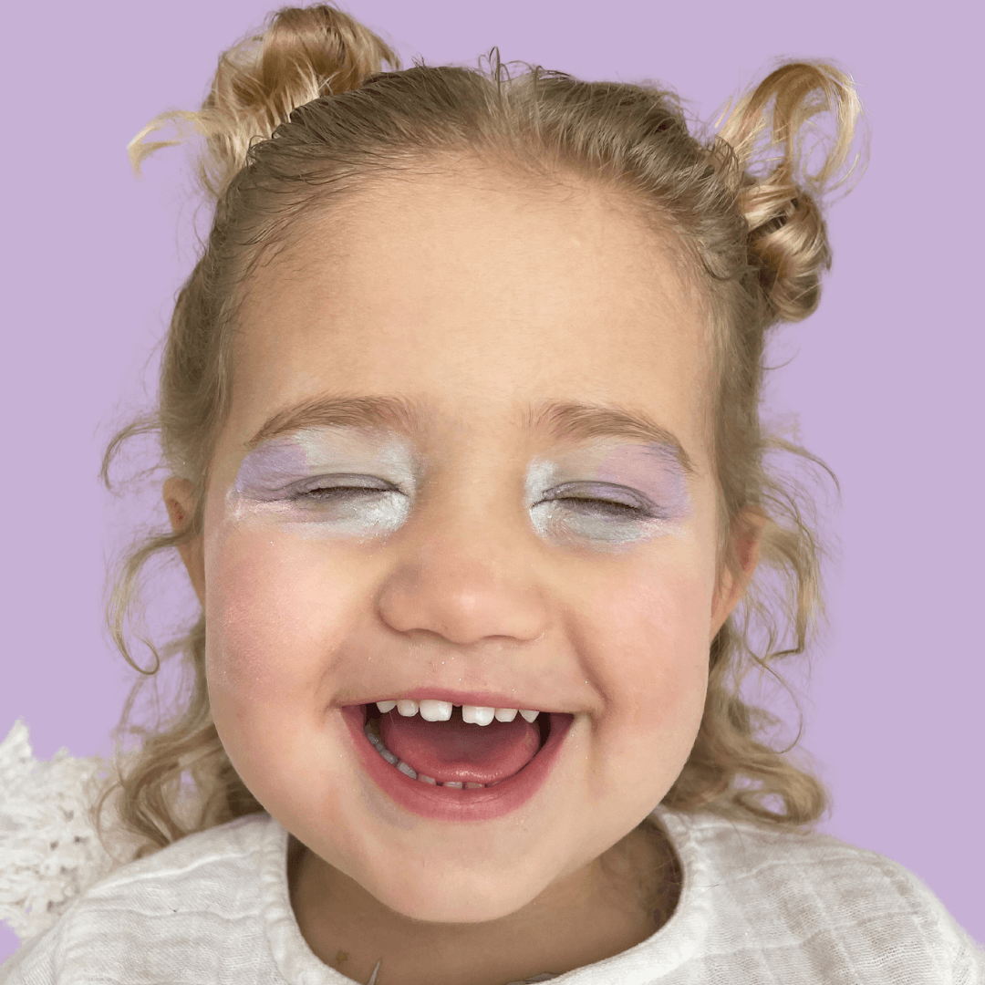 girl-laughing-with-eyes-closed-wearing-pastel-coloured-eyeshadow